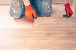 technician installing hardwood flooring